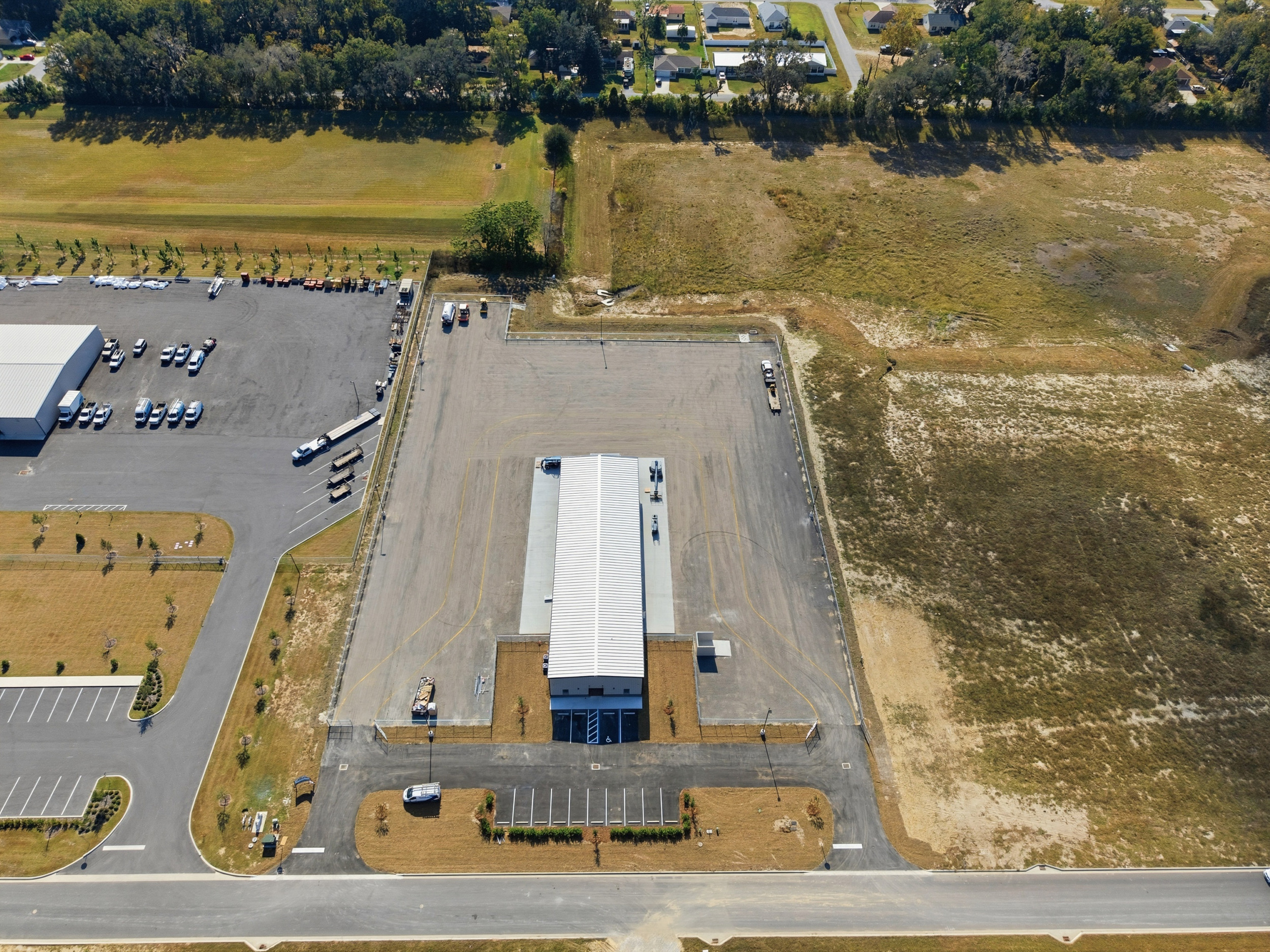 Overhead drone view of completed commercial parking lot and building