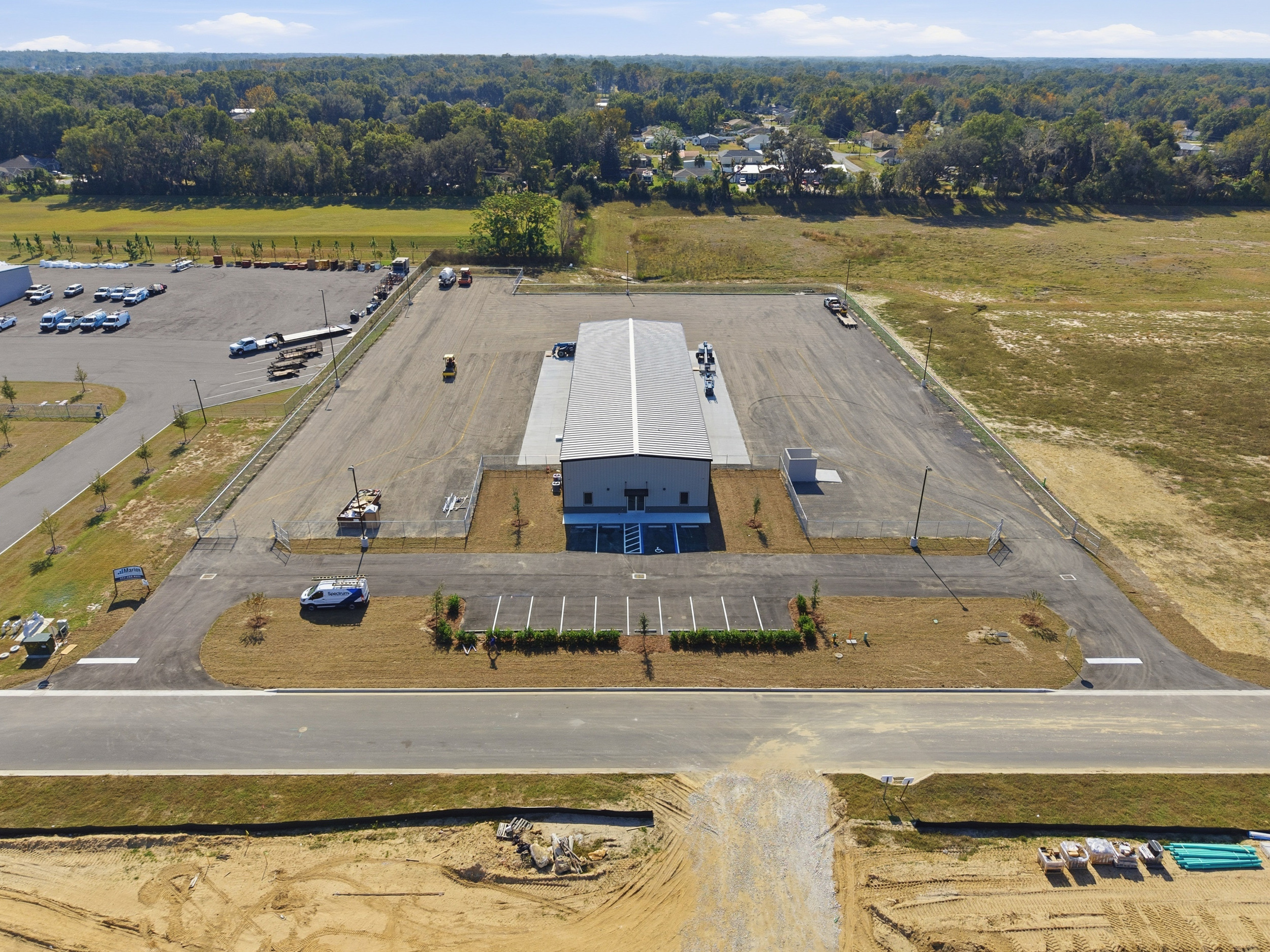 Completed commercial site development in Ocala FL with paved lot, striping, and landscaping